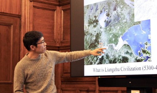 Man pointing at a presentation on Liangzhu civilisation.