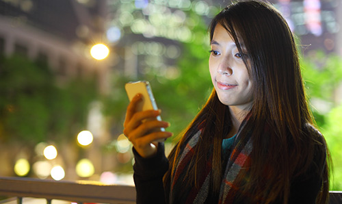 Female student looking at her mobile phone