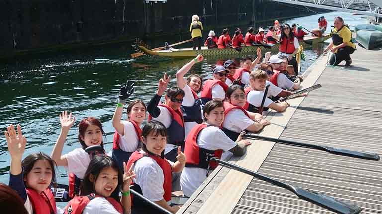 MCFP students smiling before paddling in the Dragon Boat Race