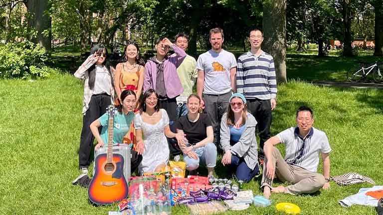 MCFP students enjoying the sunshine with a picnic in Whitworth Park