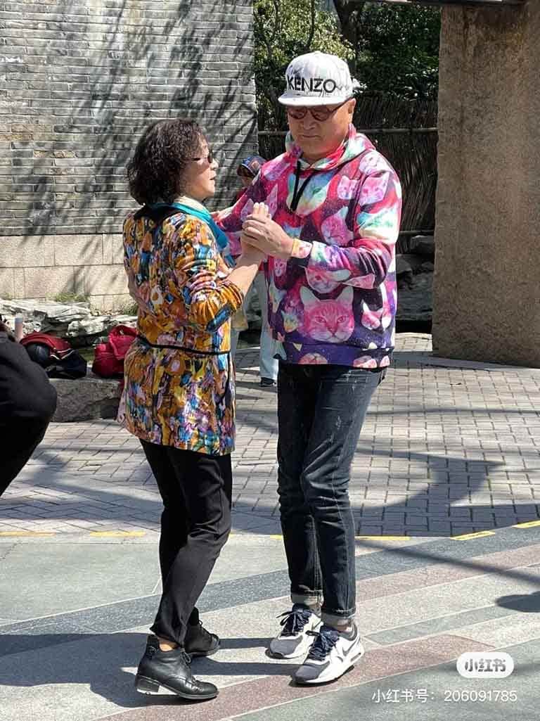 An elderly Chinese couple dancing